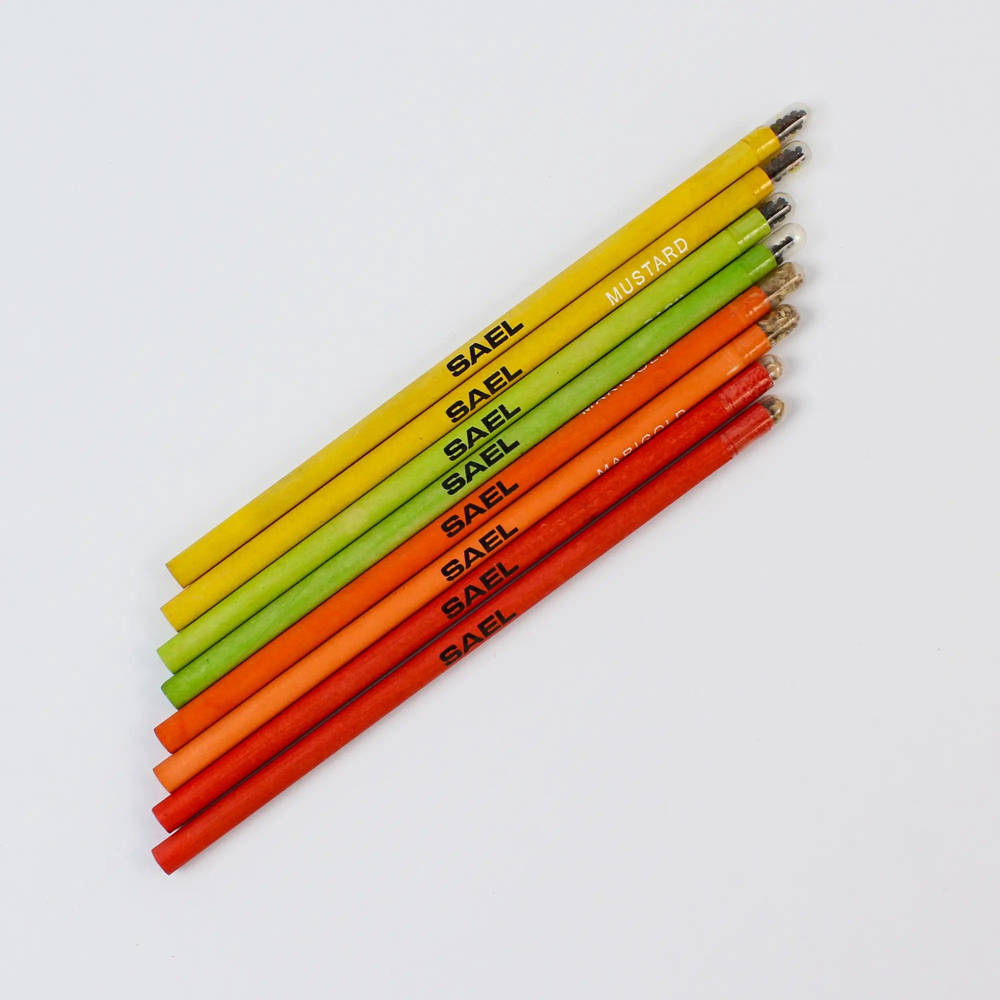 Eight seed pencils in yellow, green and orange, each printed with a company name along the body