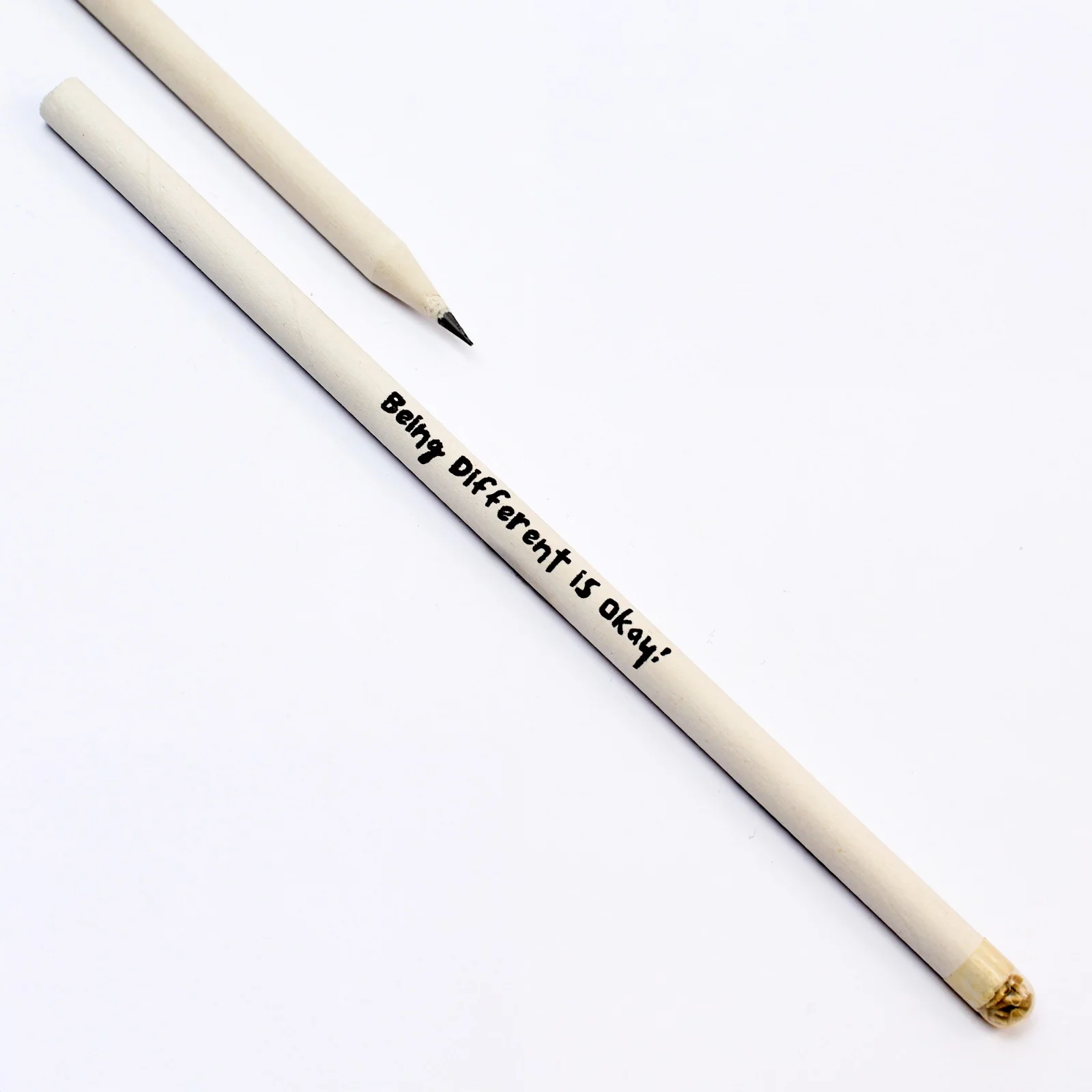 Two natural white seed pencils, one printed with a short handwritten-style message along the body