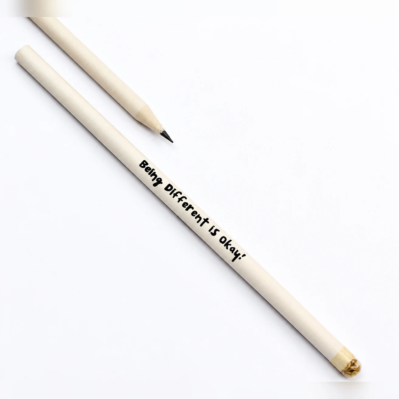 Two natural white seed pencils, one printed with a short handwritten-style message along the body