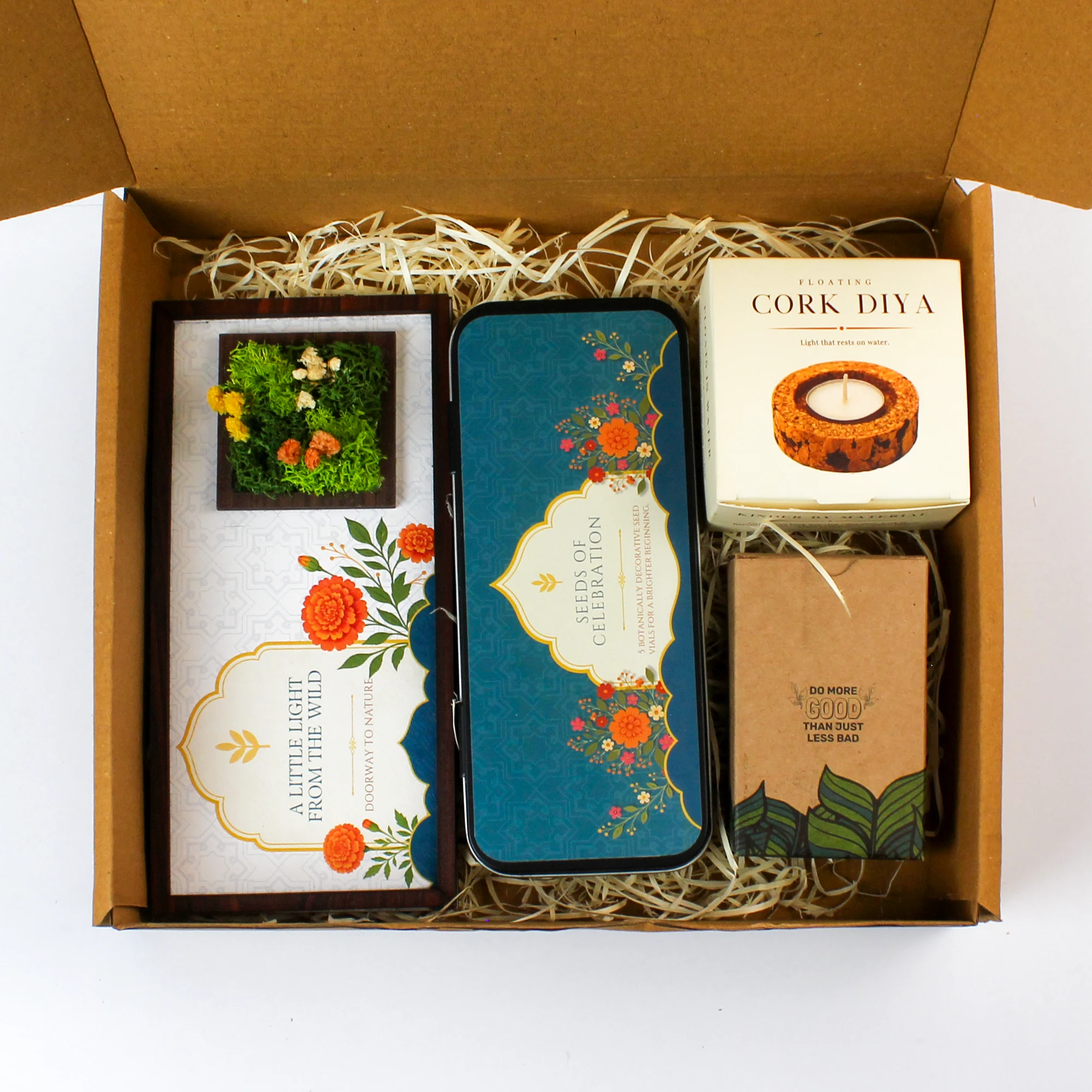 Open gift box with the Forest Window, seed-bottle tin, cork-diya pack and kraft playing-card box arranged inside