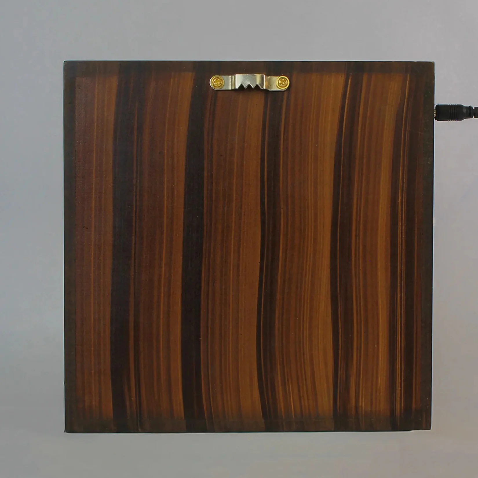 Rear of the Forest Namah MDF mandir, showing its brown back panel and power cable