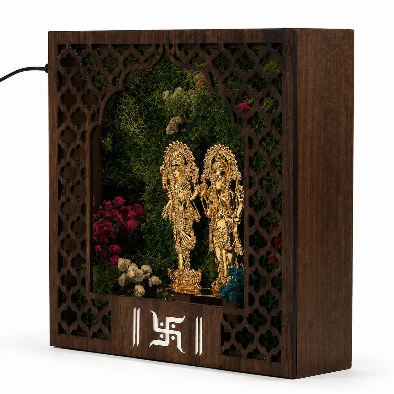 The same MDF mandir with its lighting off, showing the metal Laxmi-Ganesh idols against preserved botanicals