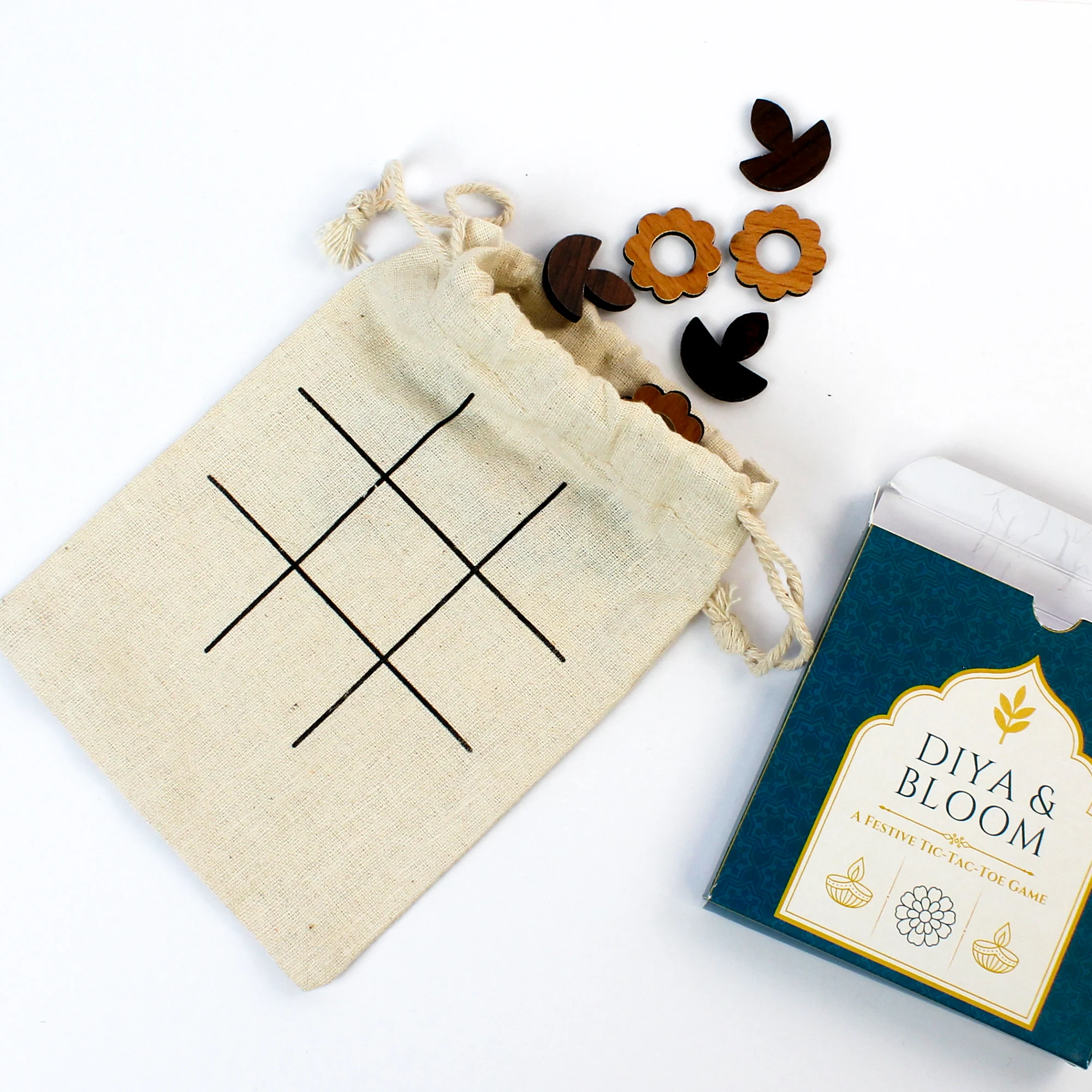 Diya and flower tic-tac-toe pieces with a cotton game pouch
