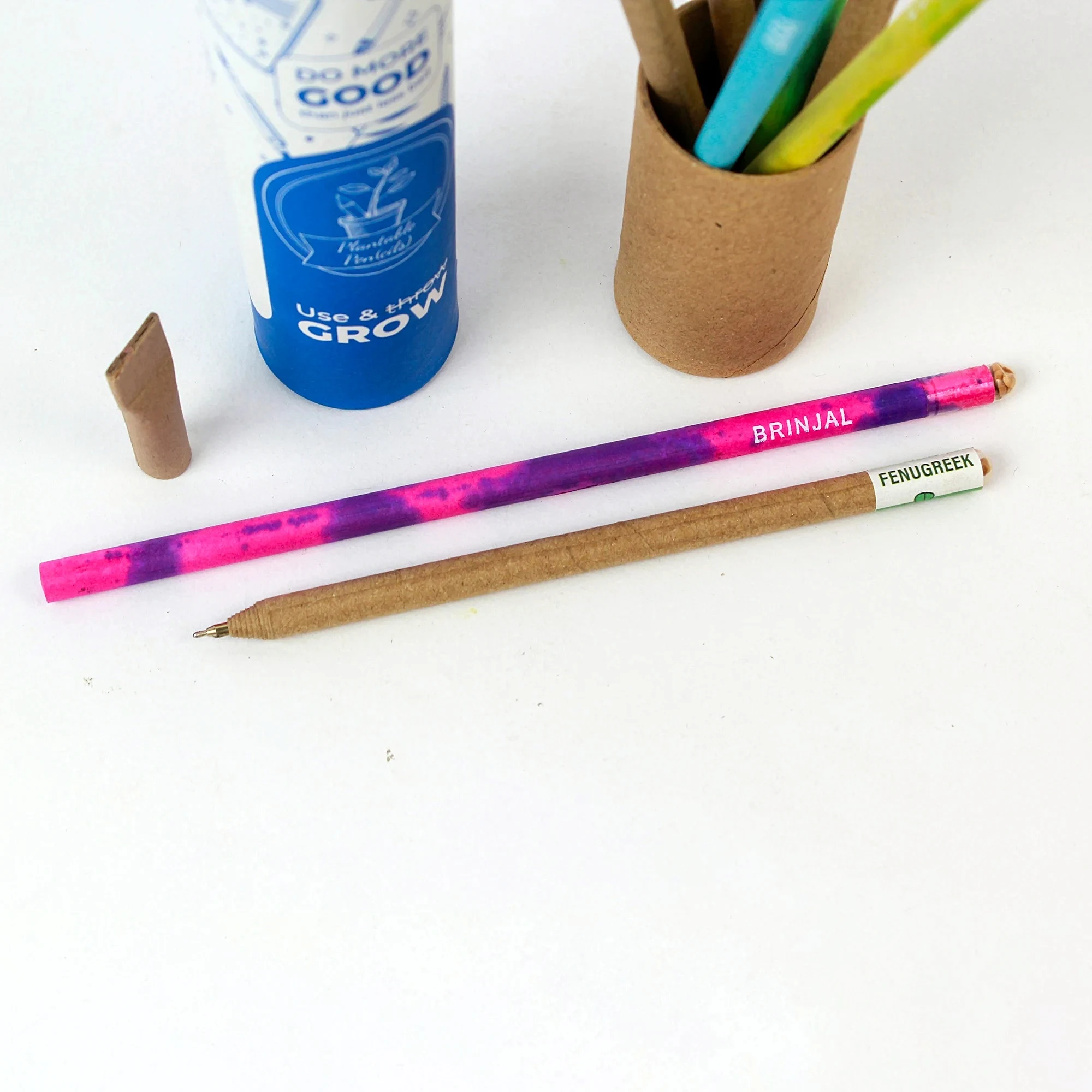 Plantable pen and pencil set shown with its paper tube